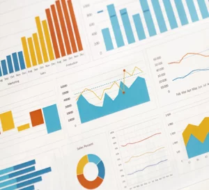 business-graphs-charts-and-magnifying-glass-on-ta